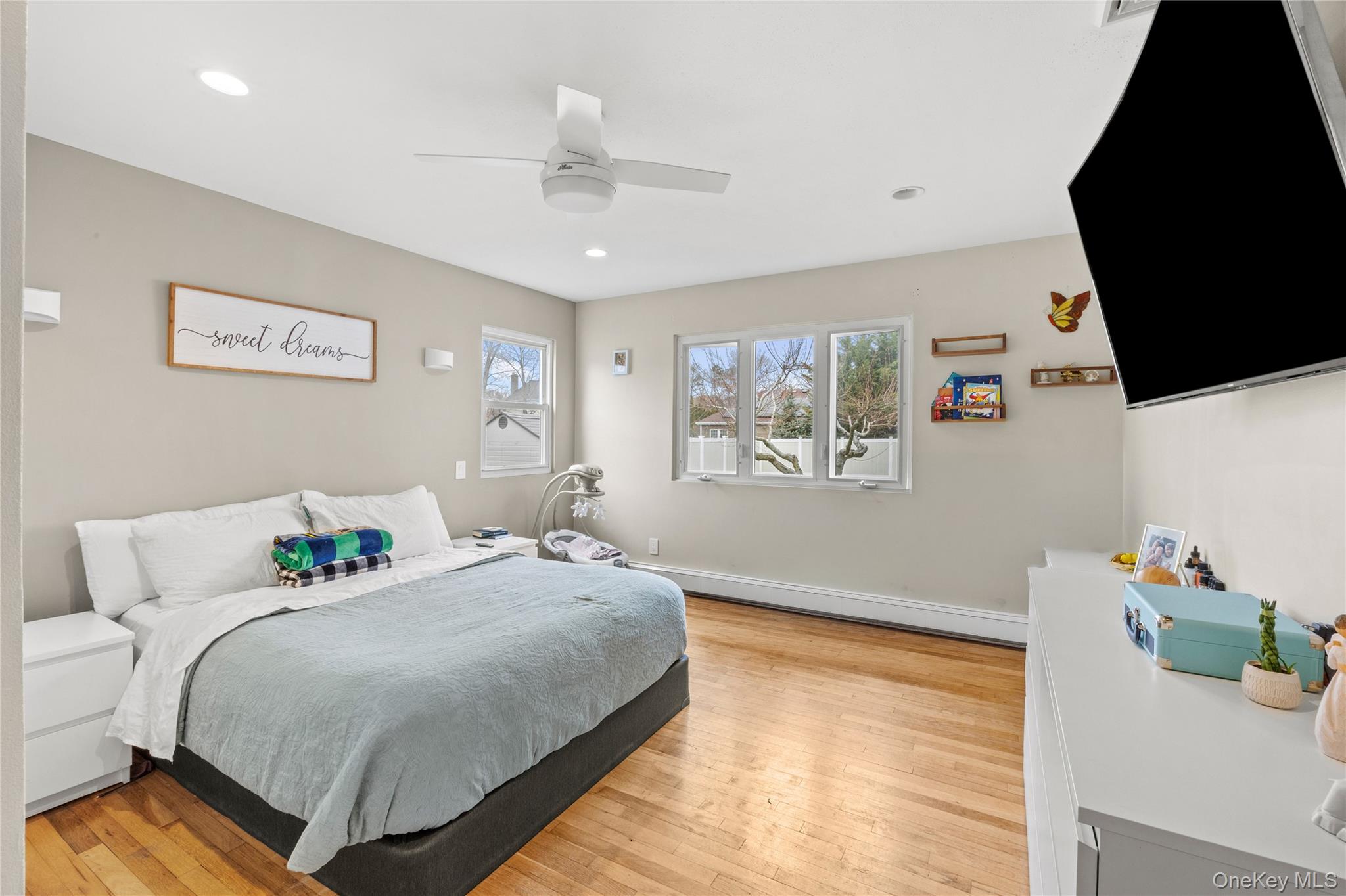 31 Halliday Road Coram, NY 11727 - Photo 14 of 30 a bedroom with a bed a flat screen tv and a dresser