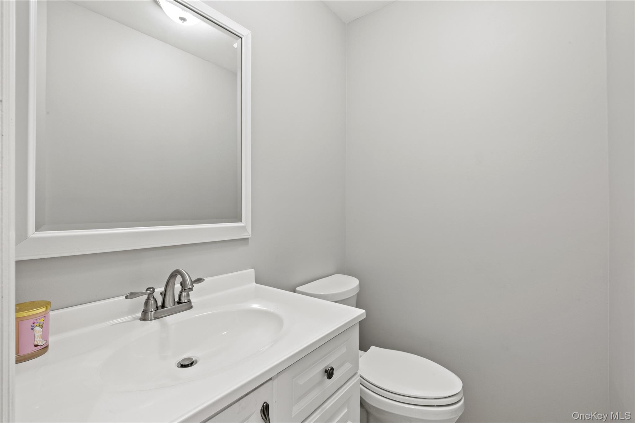 31 Halliday Road Coram, NY 11727 - Photo 16 of 30 a bathroom with a sink a toilet and mirror