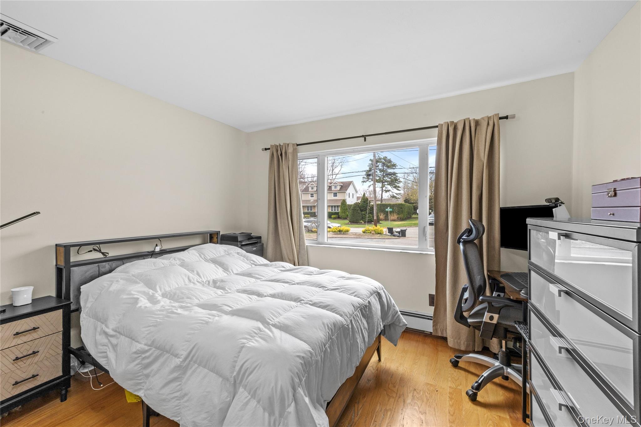 31 Halliday Road Coram, NY 11727 - Photo 17 of 30 a bed sitting in a bedroom next to a window