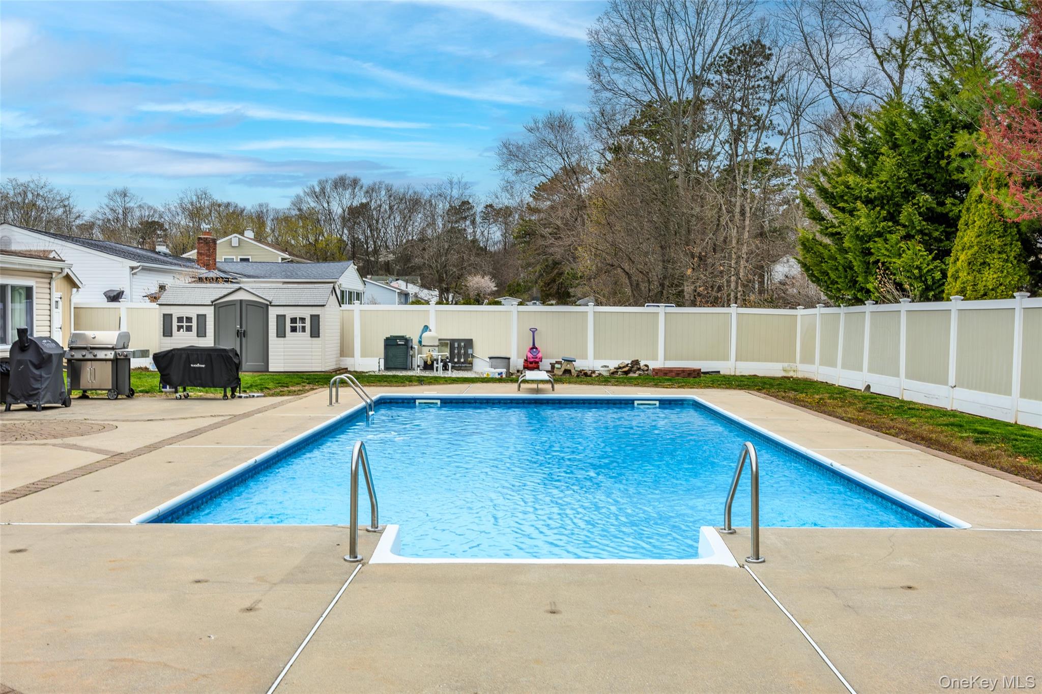 31 Halliday Road Coram, NY 11727 - Photo 24 of 30 a view of a swimming pool with a lounge chairs