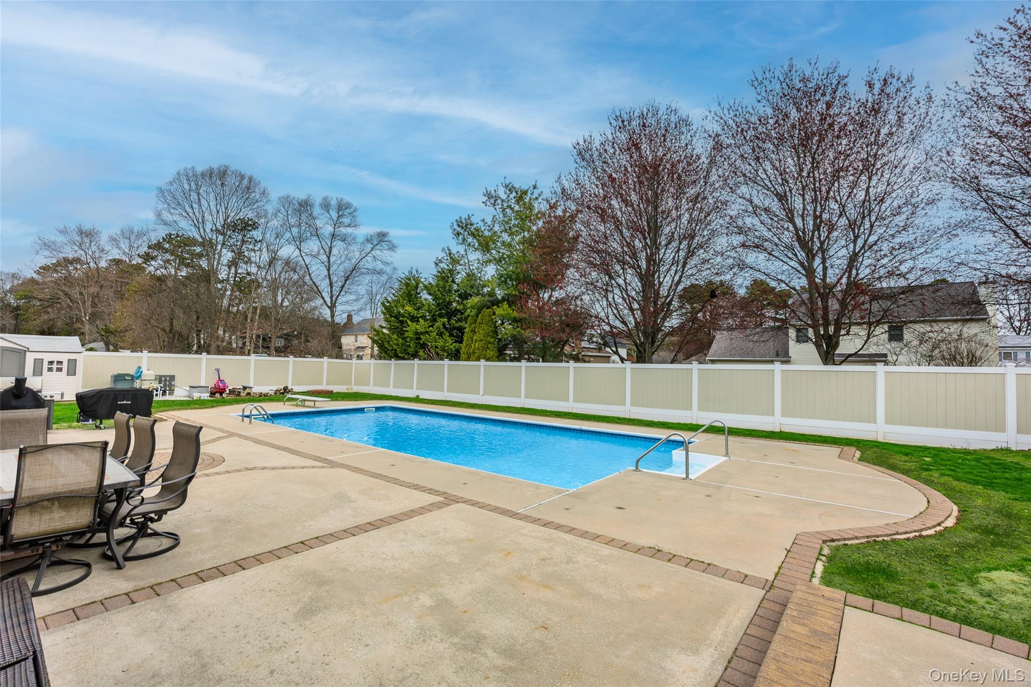 31 Halliday Road Coram, NY 11727 - Photo 27 of 30 a view of a swimming pool with a lounge chair