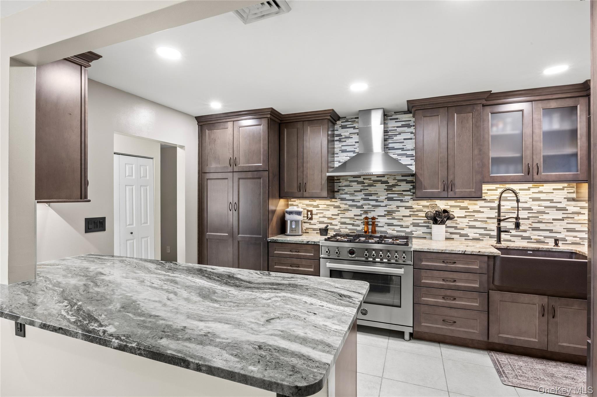 31 Halliday Road Coram, NY 11727 - Photo 3 of 30 a kitchen with stainless steel appliances kitchen island granite countertop a stove and cabinets