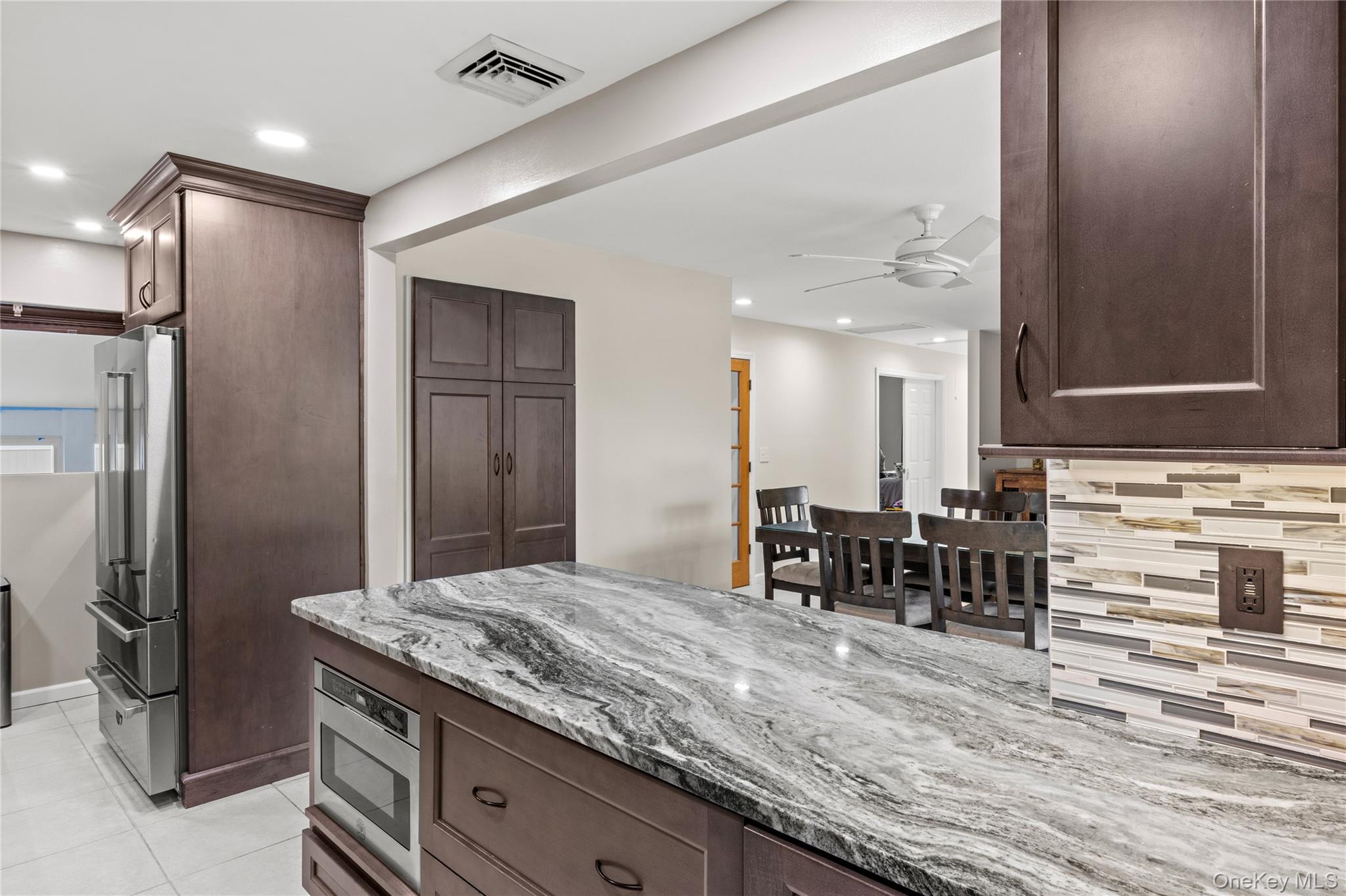 31 Halliday Road Coram, NY 11727 - Photo 8 of 30 a kitchen with stainless steel appliances granite countertop a sink and a refrigerator