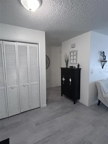 wooden floor in an entryway with a hallway