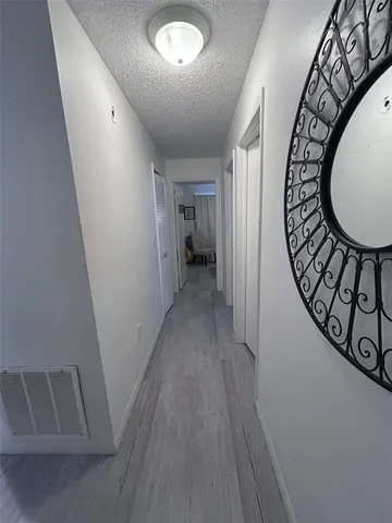 a spacious bedroom with a bed and a chandelier