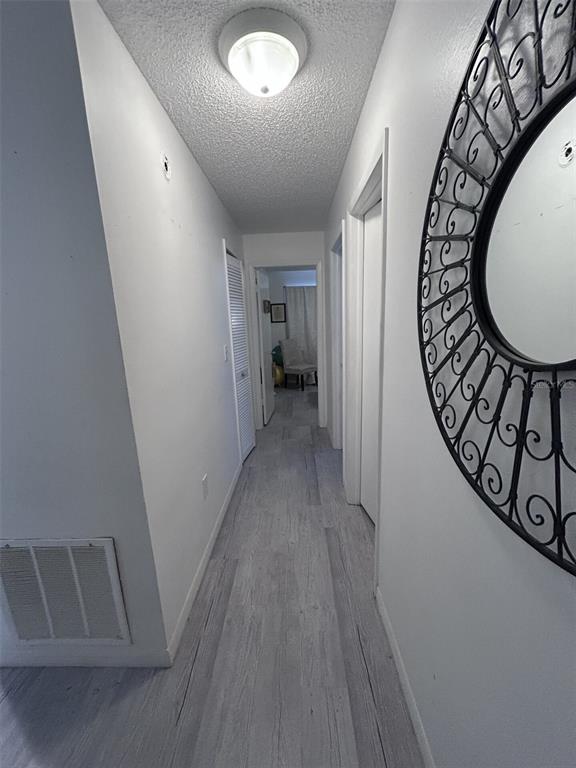 1495 Bishop Road Spring Hill, FL 34608 - Photo 12 of 34 wooden floor in an entryway with a hallway