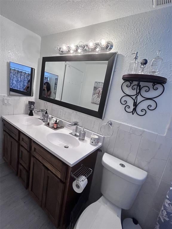 1495 Bishop Road Spring Hill, FL 34608 - Photo 15 of 34 a bathroom with a toilet sink and mirror