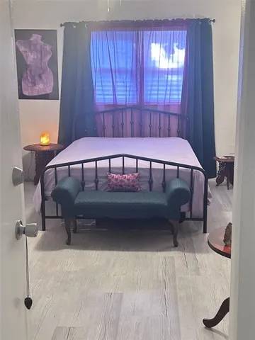 a bedroom with a bed and a table chair