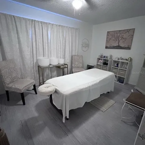 a spacious bedroom with a bed a couch and dresser