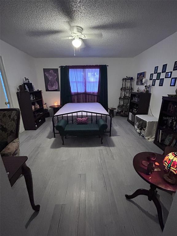 1495 Bishop Road Spring Hill, FL 34608 - Photo 18 of 34 a spacious bedroom with a bed a couch and dresser