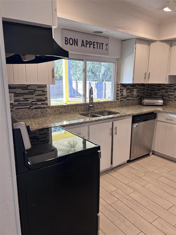 1495 Bishop Road Spring Hill, FL 34608 - Photo 23 of 34 a kitchen with a sink and cabinets