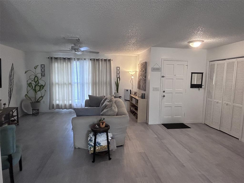 1495 Bishop Road Spring Hill, FL 34608 - Photo 6 of 34 a living room with furniture and a chandelier