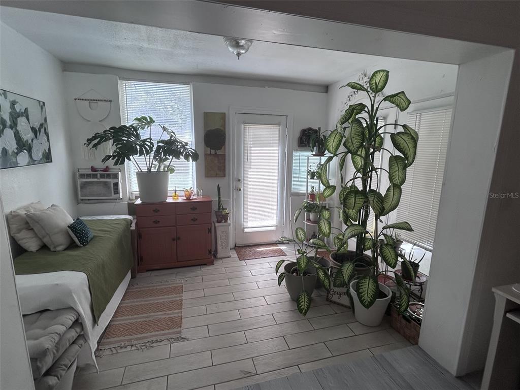 1495 Bishop Road Spring Hill, FL 34608 - Photo 9 of 34 a living room with furniture and a potted plant