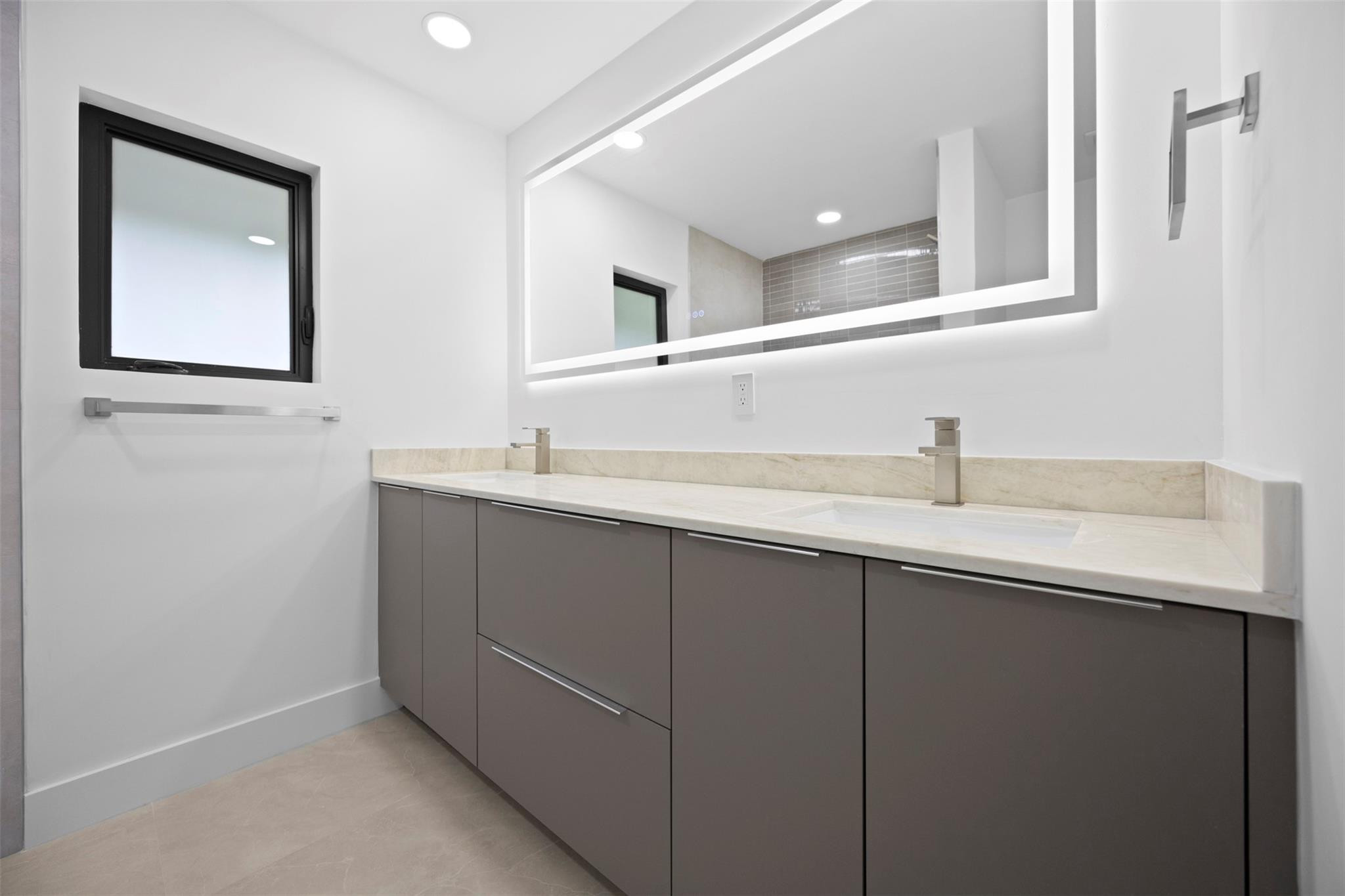 7571 Estrella Circle Boca Raton, FL 33433 - Photo 47 of 79 a bathroom with a double vanity sink and mirror