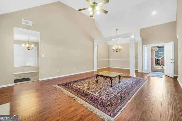 wooden floor with a rug and a window