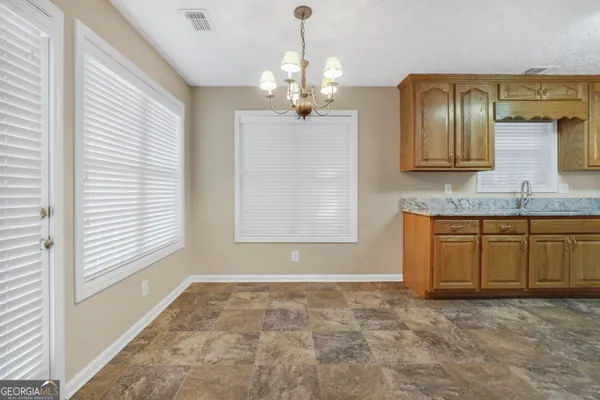 a view of a kitchen with granite countertop cabinets and wooden floor