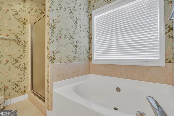 a bathroom with a tub and a shower