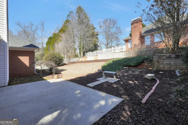 a view of a yard with a house in the background