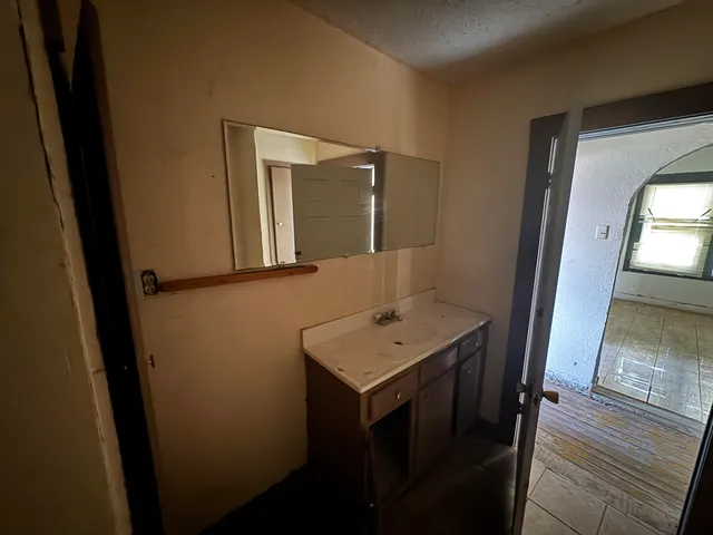 a bathroom with a sink a mirror and a toilet