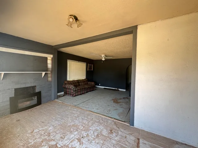 a view of a livingroom with wooden floor and a fireplace