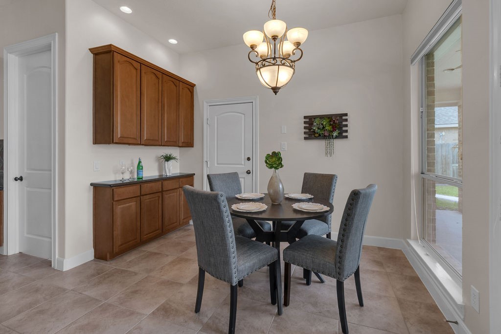 7306 Starflower Katy, TX 77494 - Photo 18 of 50 a view of a dining room with furniture and chandelier