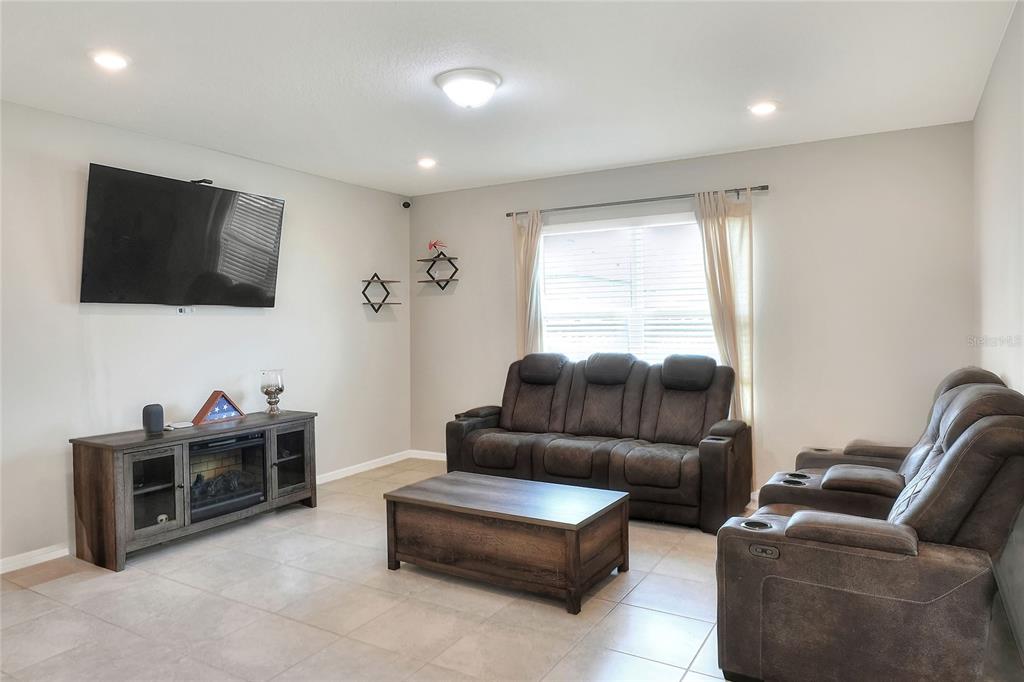 1623 Aspen Avenue Davenport, FL 33837 - Photo 14 of 43 a living room with furniture and a flat screen tv