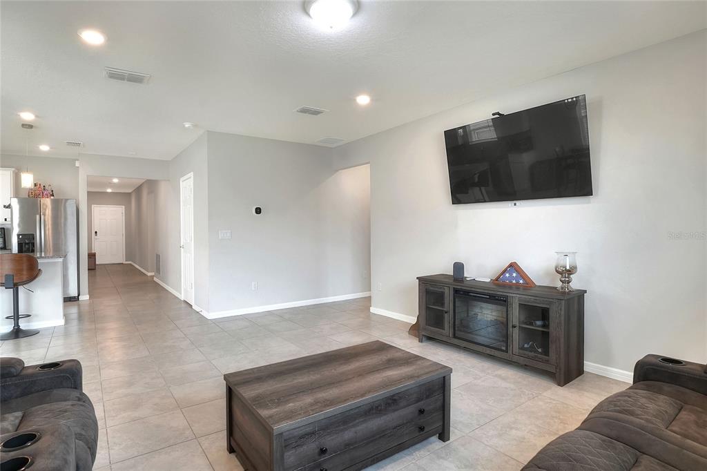 1623 Aspen Avenue Davenport, FL 33837 - Photo 15 of 43 a living room with furniture and a flat screen tv