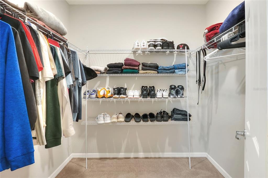 1623 Aspen Avenue Davenport, FL 33837 - Photo 24 of 43 a view of walk in closet with clothes and shoes