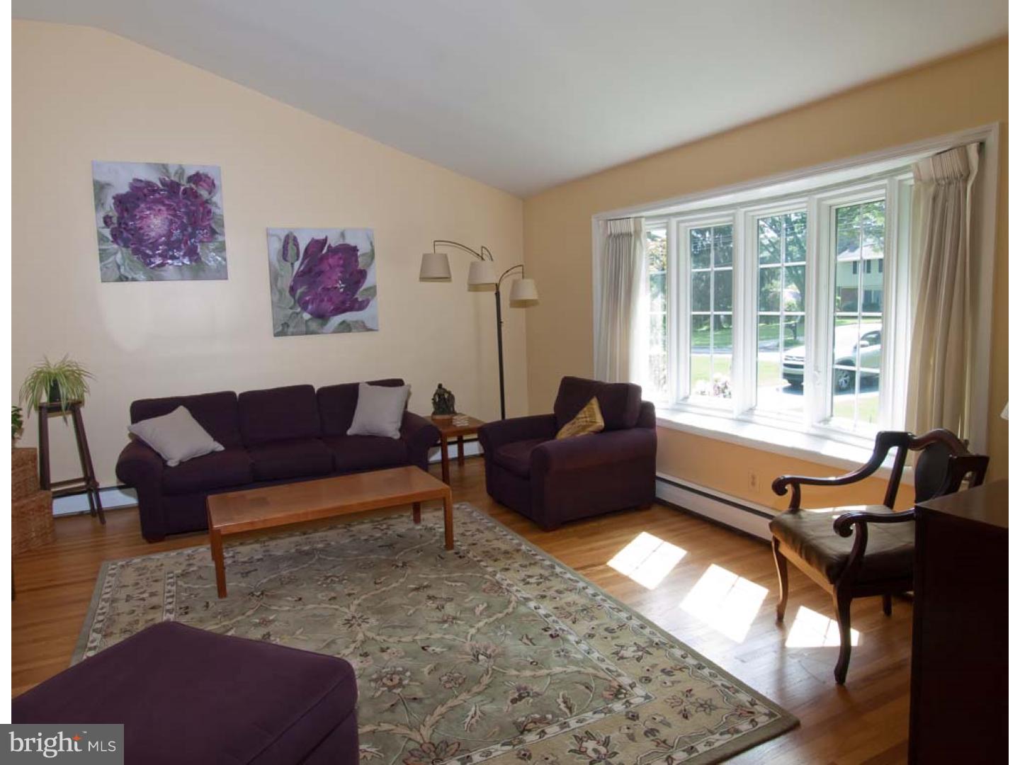 275 Old State Road Berwyn, PA 19312 - Photo 4 of 21 a living room with furniture fireplace and a large window