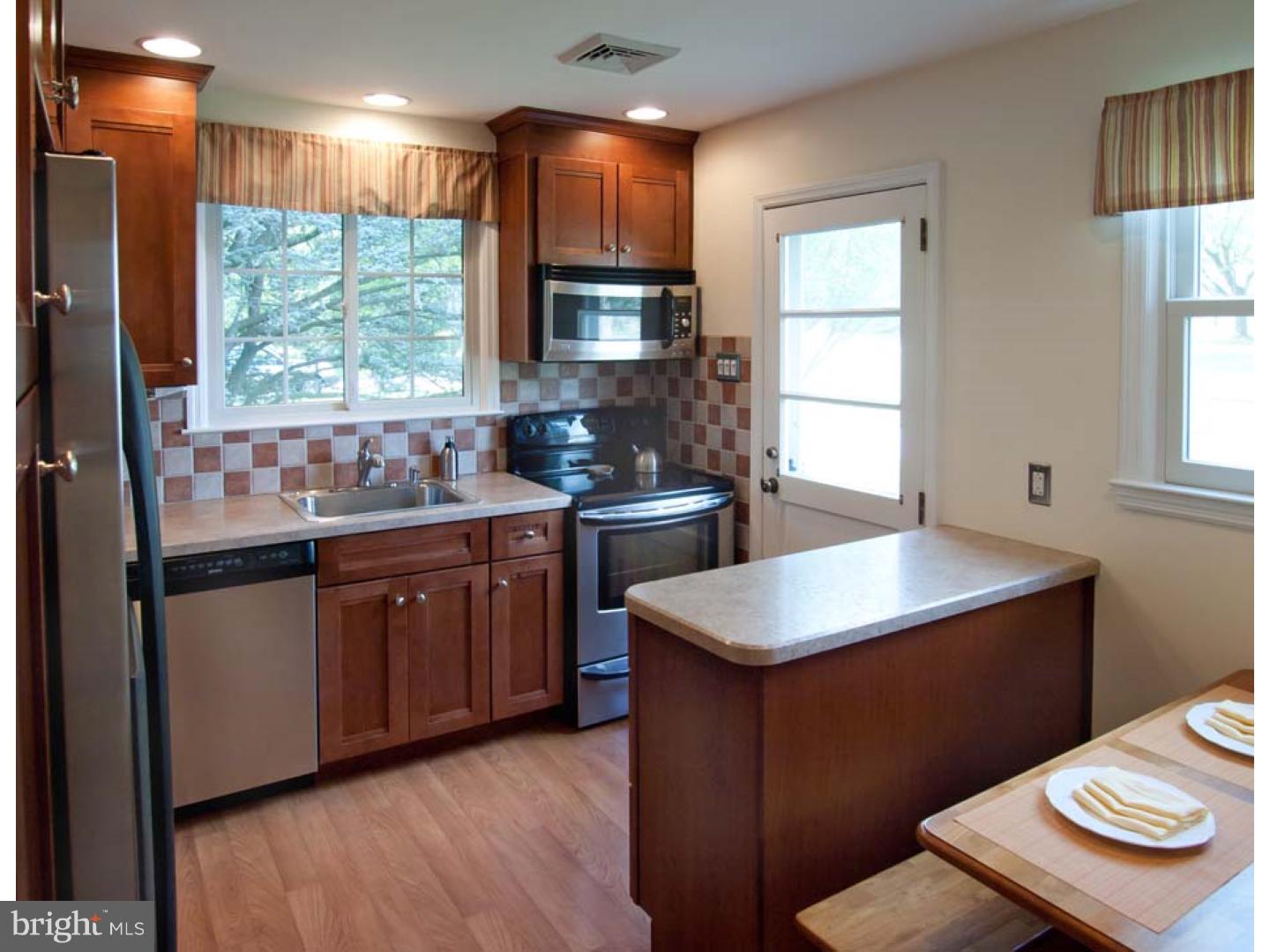 275 Old State Road Berwyn, PA 19312 - Photo 8 of 21 a kitchen with a sink window and cabinets