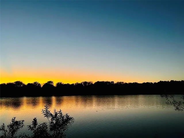 a view of lake with sunset