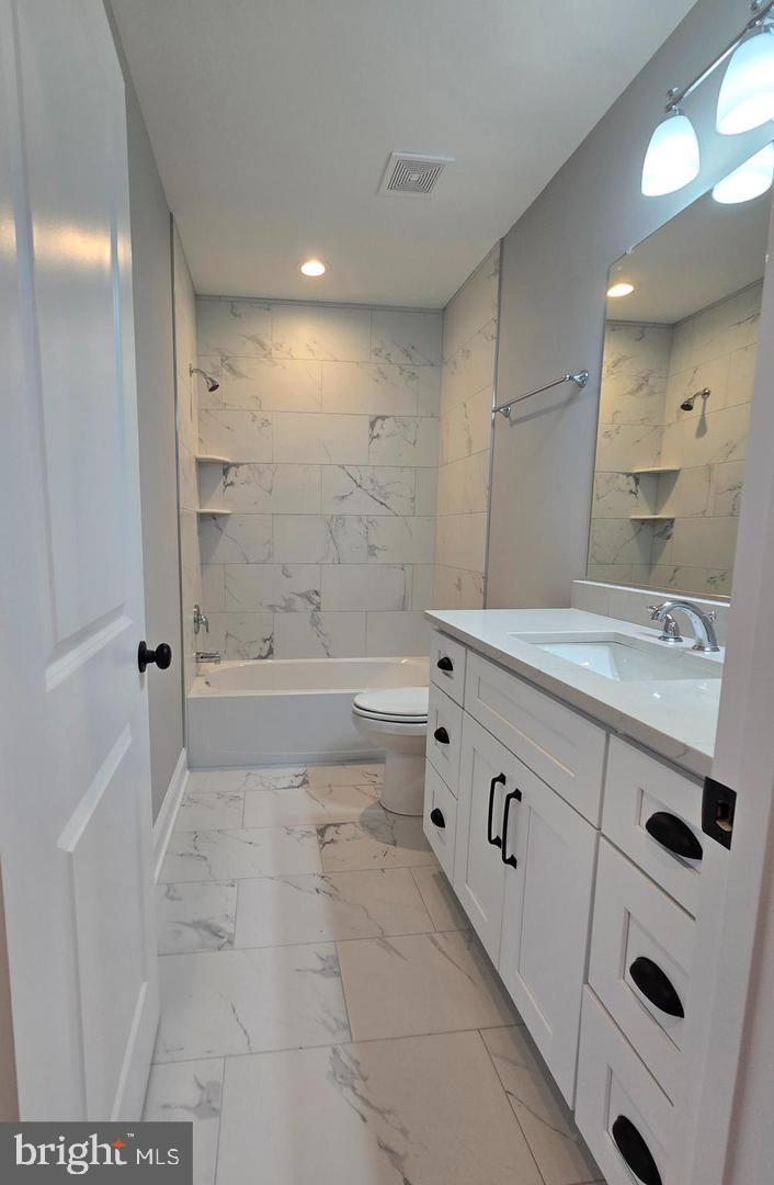 8478 Garden Road Pasadena, MD 21122 - Photo 11 of 14 a bathroom with a sink a toilet and shower