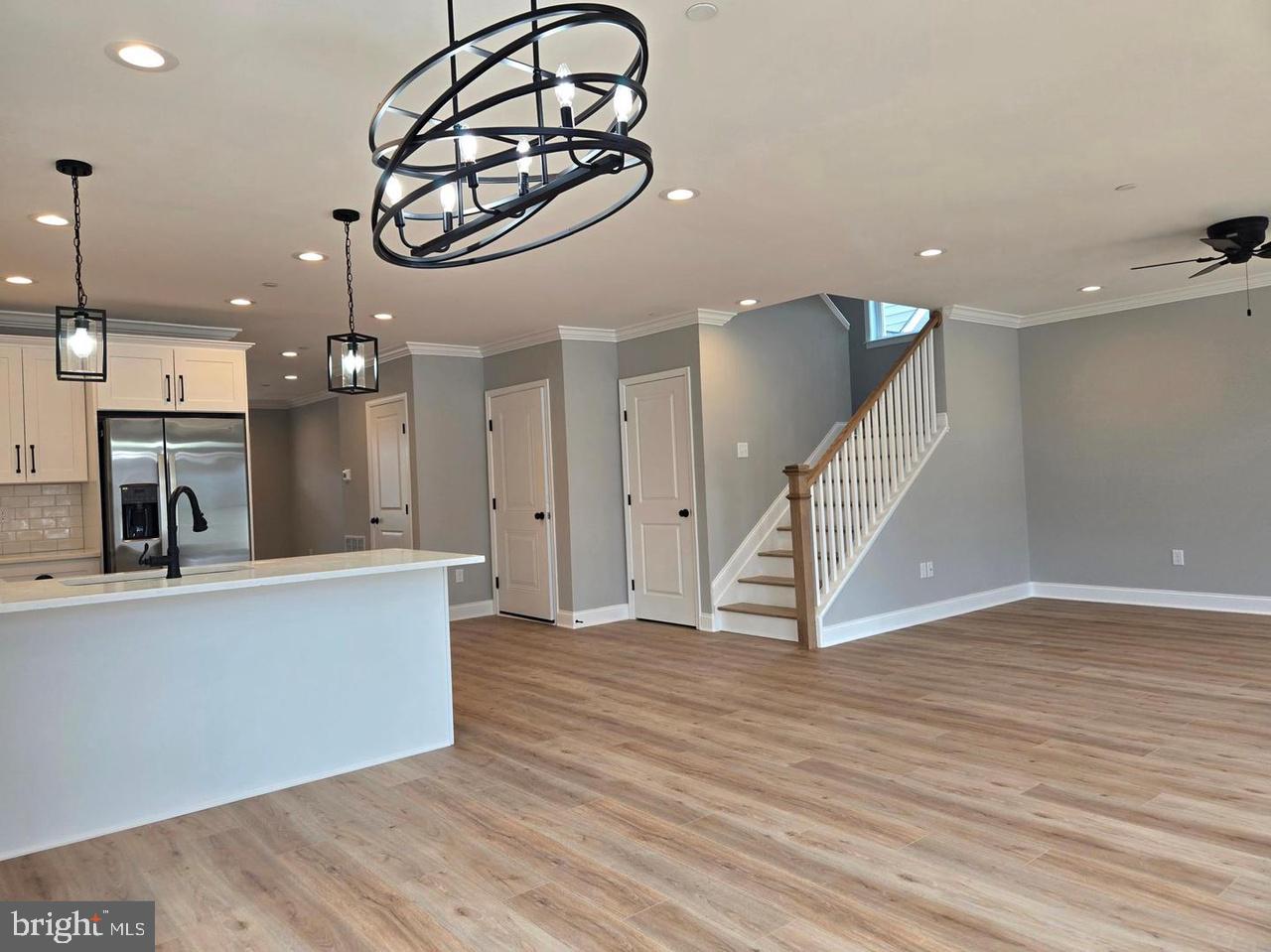 8478 Garden Road Pasadena, MD 21122 - Photo 2 of 14 a view of a livingroom with furniture wooden floor and staircase
