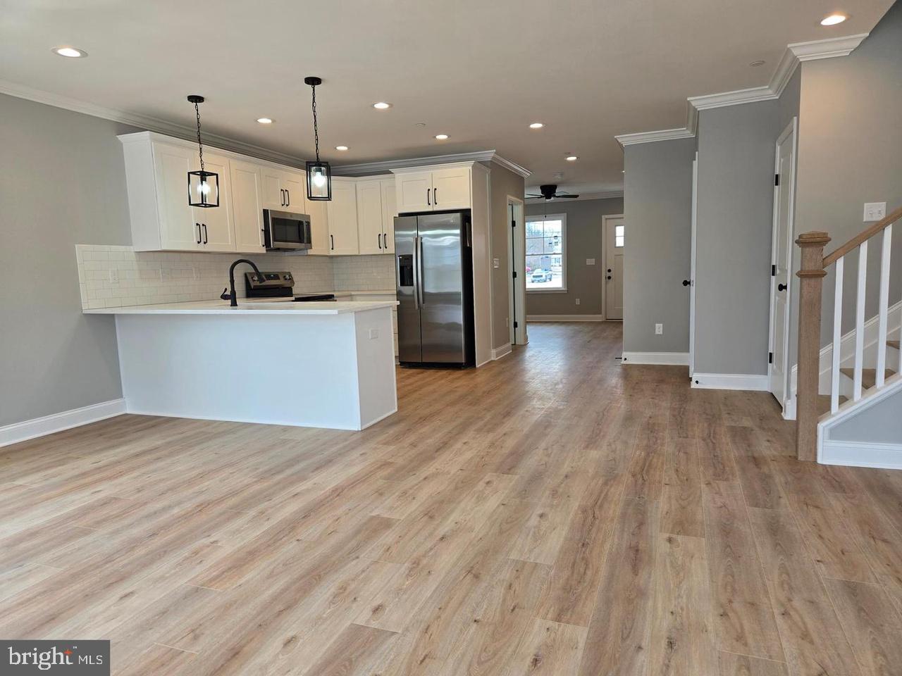 8478 Garden Road Pasadena, MD 21122 - Photo 3 of 14 a view of kitchen with stainless steel appliances kitchen island wooden floors and center island
