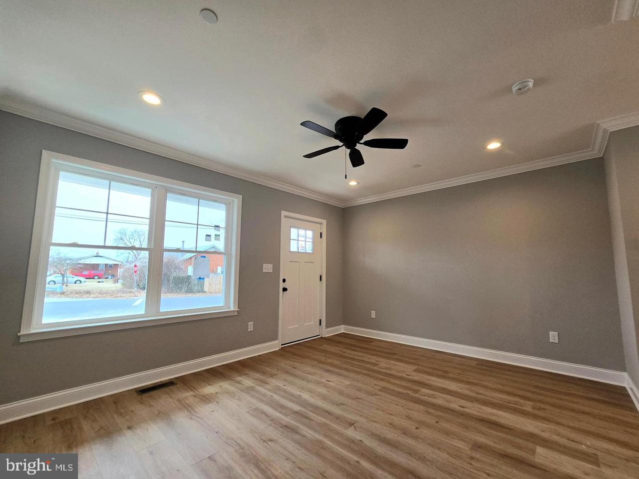 8478 Garden Road Pasadena, MD 21122 - Photo 6 of 14 wooden floor in an empty room with a window