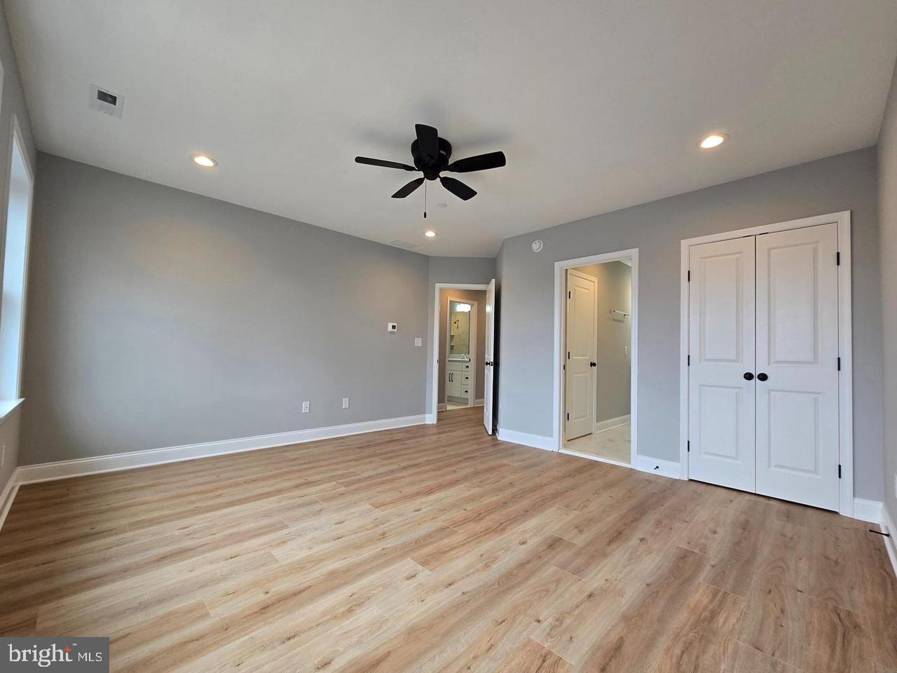 8478 Garden Road Pasadena, MD 21122 - Photo 8 of 14 a view of an empty room with a ceiling fan