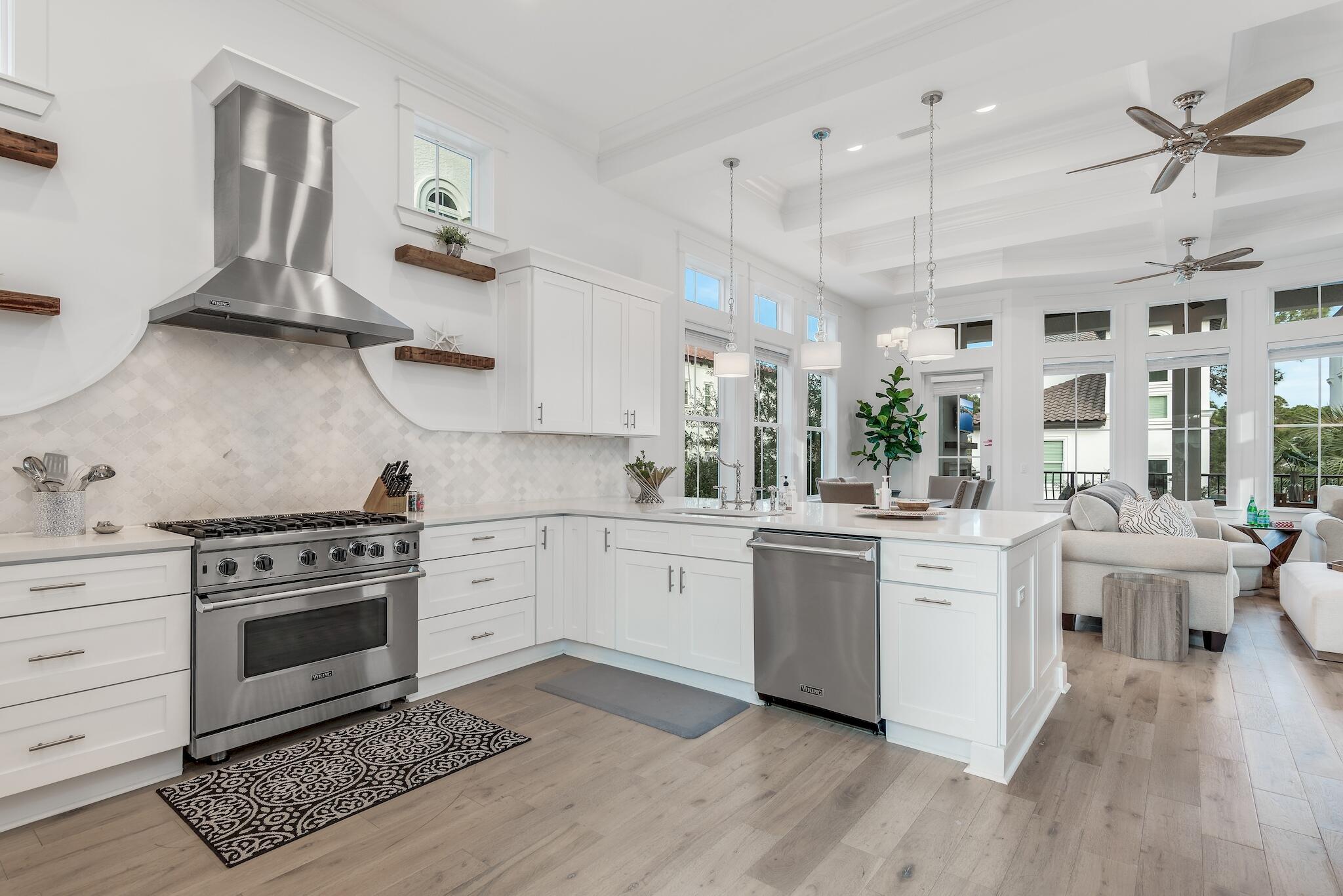 81 Palmeira Way Santa Rosa Beach, FL 32459 - Photo 30 of 74 a kitchen with white cabinets stainless steel appliances and wooden floor