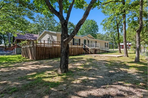 a front view of a house with a yard garage and tree