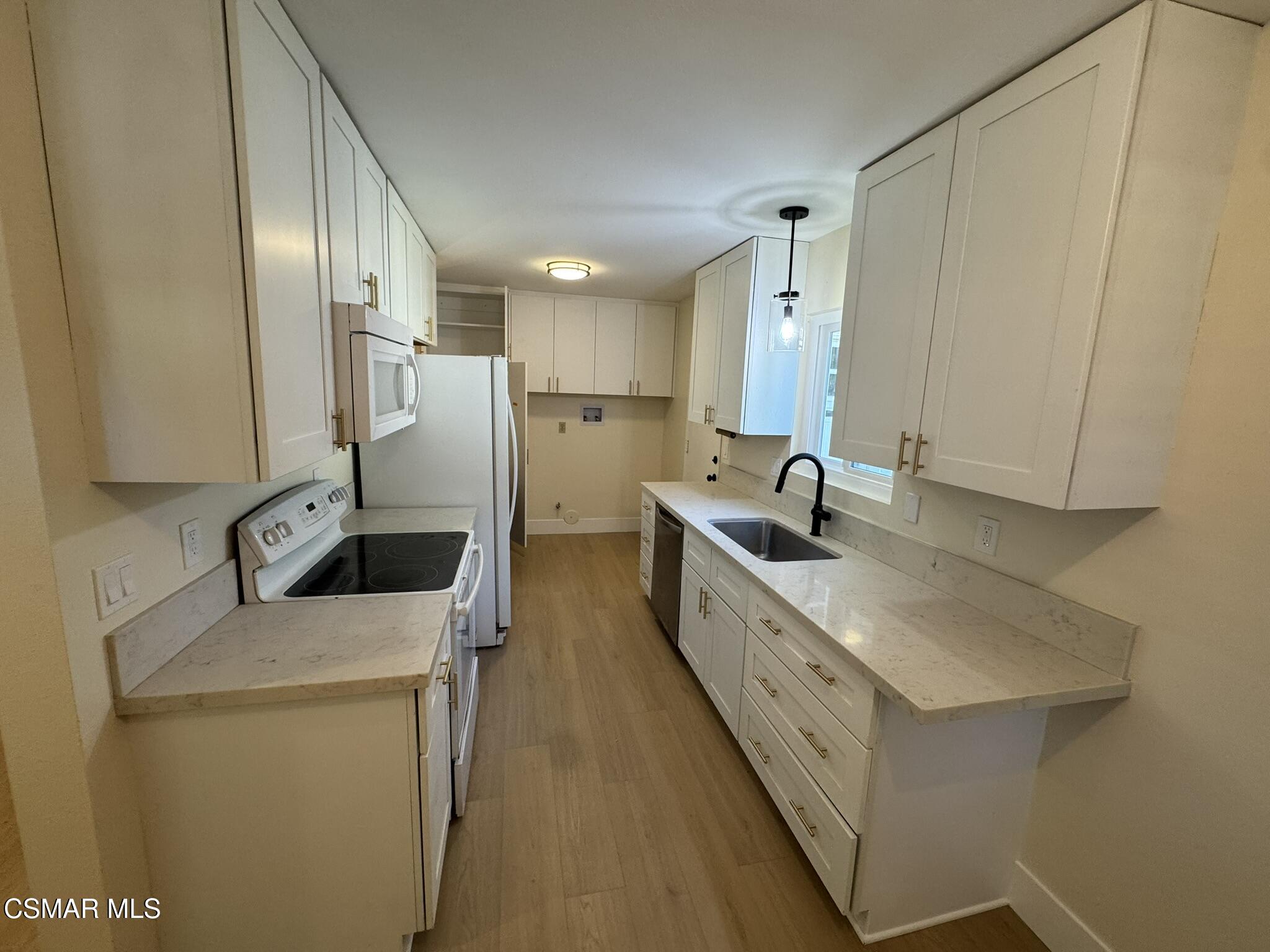 1567 Sequoia Avenue Simi Valley, CA 93063 - Photo 10 of 18 a kitchen with sink a refrigerator and cabinets