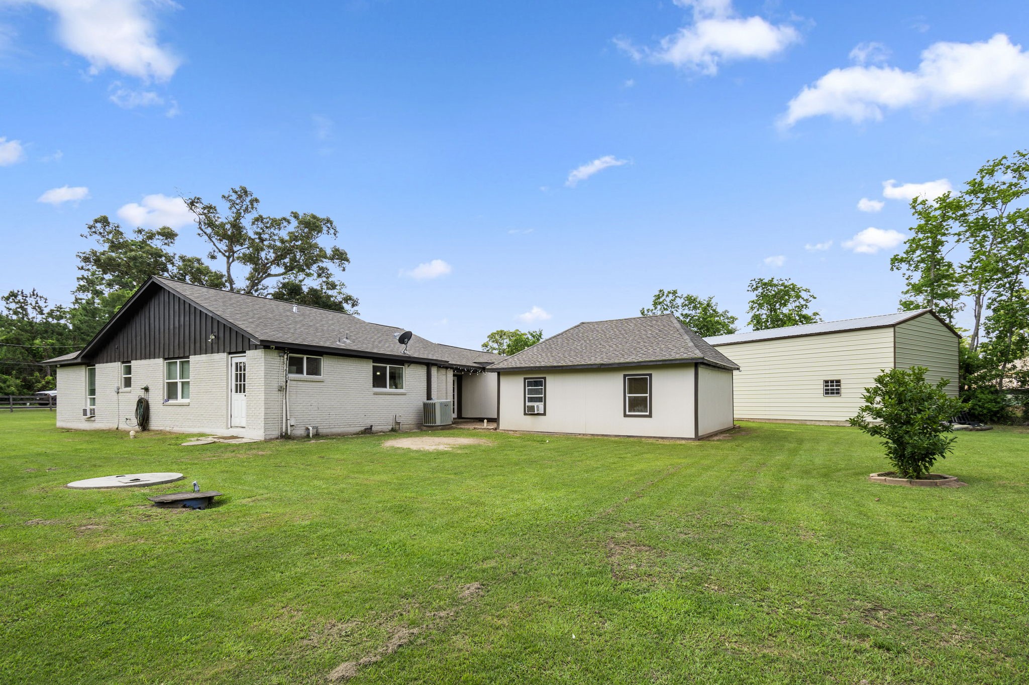 25311 Hardin Store Road Pinehurst, TX 77362 - Photo 30 of 39 a front view of a house with a yard and trees