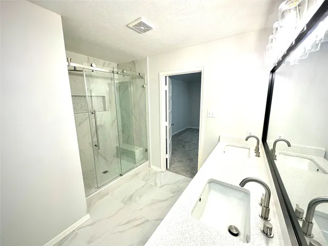 a bathroom with a sink and shower