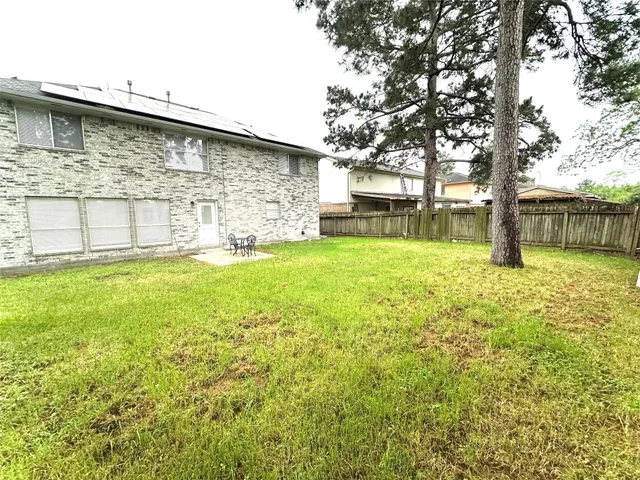 a view of a backyard with plants and a patio