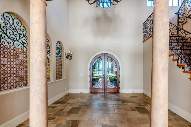 an empty room with windows and furniture