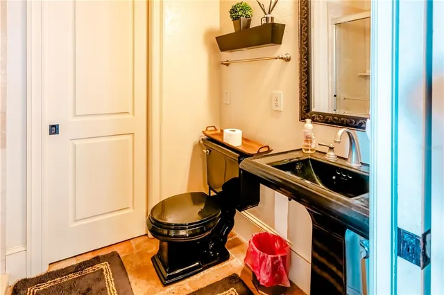 a bathroom with a sink a toilet and a mirror