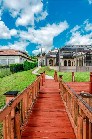 a view of a lake with couches chairs and a big yard
