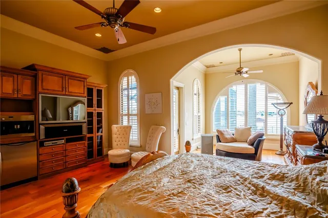 a bedroom with furniture and a large window