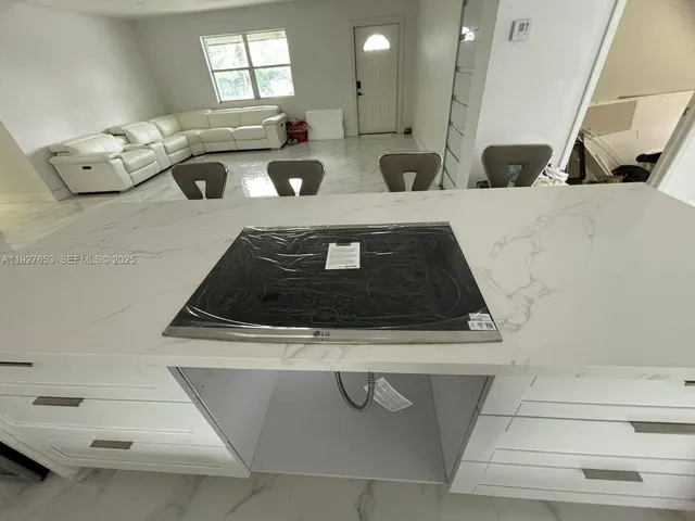 a kitchen with a stove and white cabinets