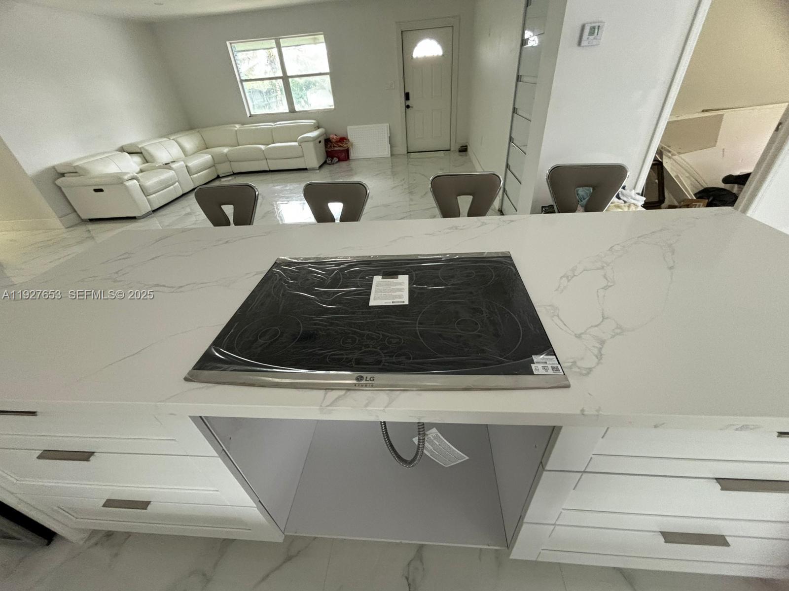 a kitchen with a stove and white cabinets