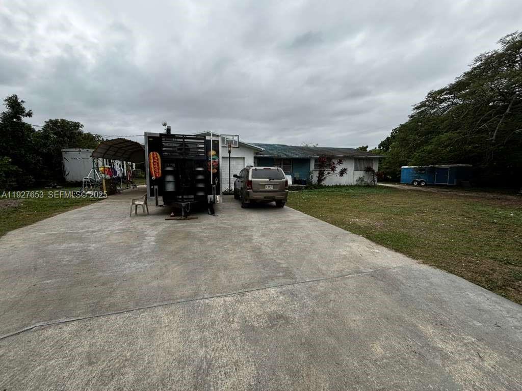 21160 Southwest 328th Street Homestead, FL 33030 - Photo 12 of 18 a view of car parked in front of house