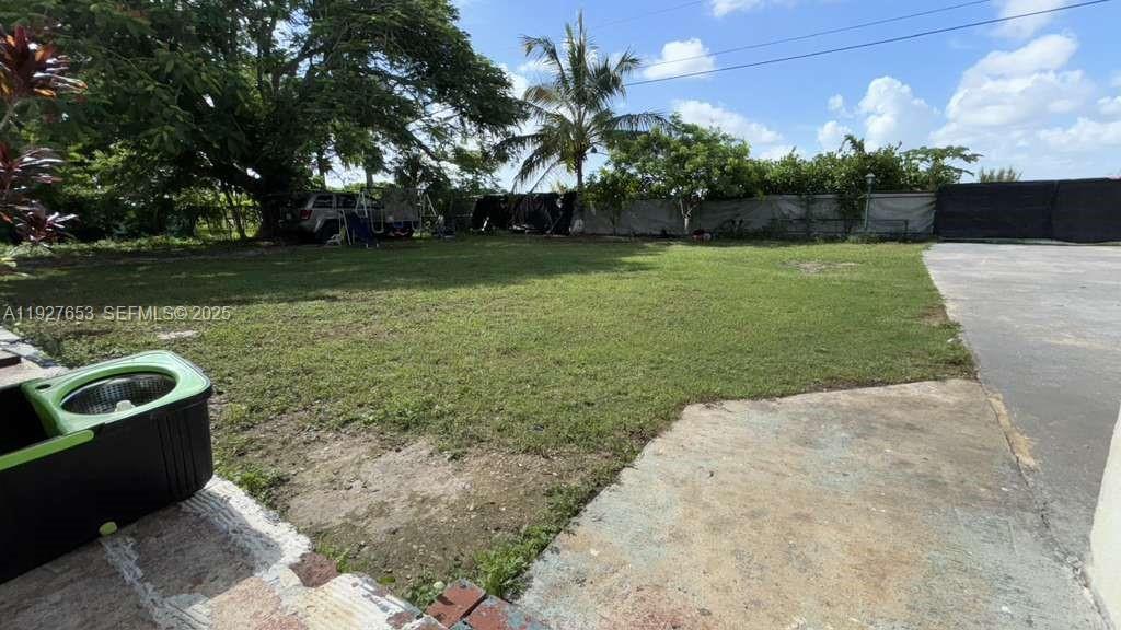 21160 Southwest 328th Street Homestead, FL 33030 - Photo 13 of 18 a view of a swimming pool with a yard